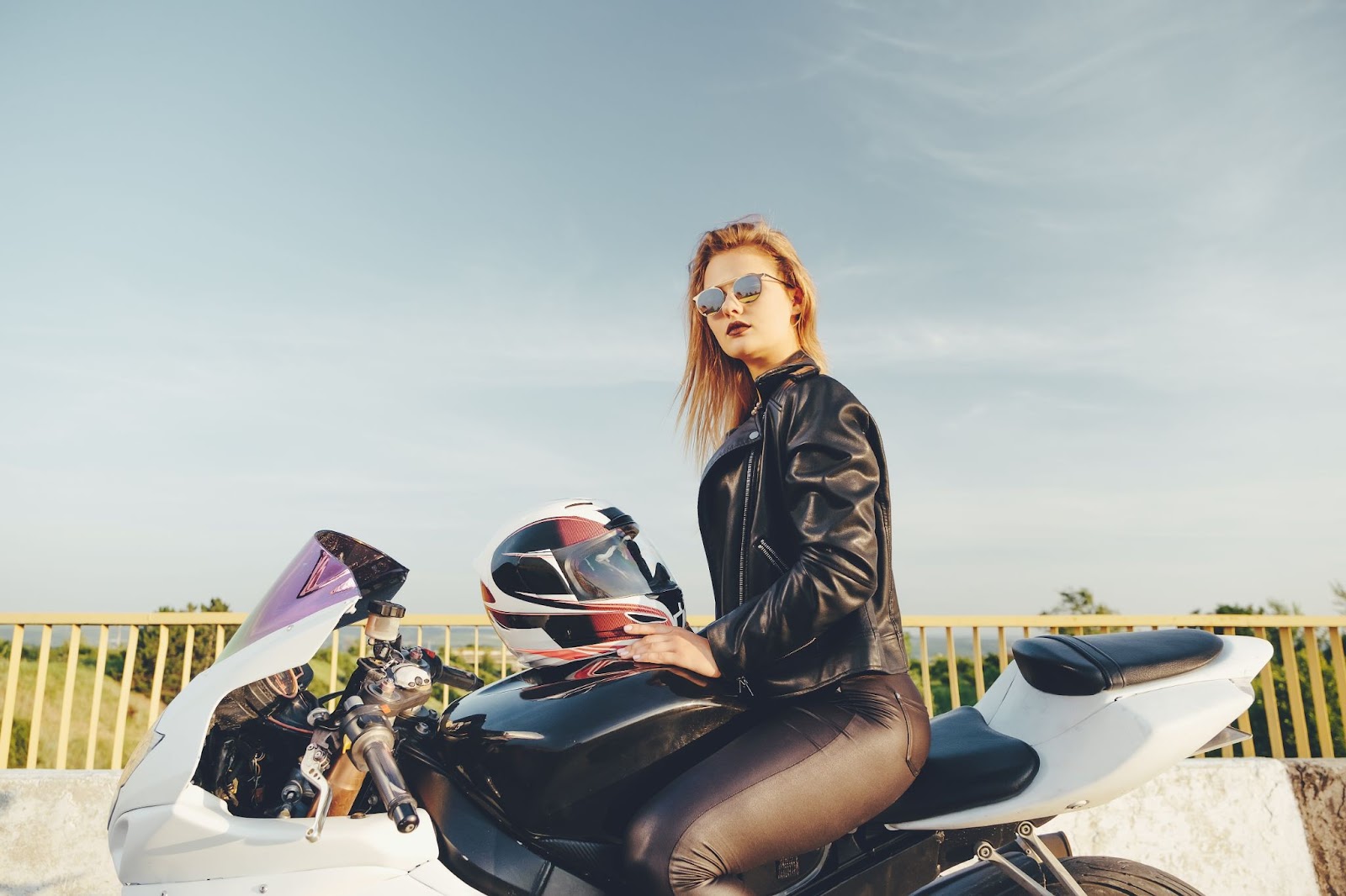 woman with sunglasses driving on motorbike